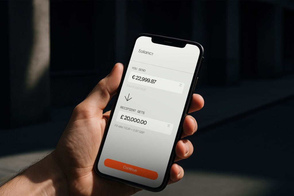 Person holding a phone displaying Solance foreign exchange and multi-currency management